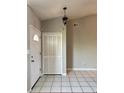 Bright entryway featuring tile flooring, a coat closet, and a white front door at 1509 Jason St, Kissimmee, FL 34744