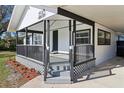 Inviting covered front porch with black railings and freshly painted trim at 1518 Coletta Dr, Orlando, FL 32807