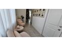 Bright entryway featuring seating beneath a gallery wall of framed Gathering photos at 15742 Vetta Dr, Bella Collina, FL 34756