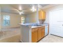 Open kitchen with breakfast bar overlooking a light-filled living area, promoting an airy feel at 19920 Villa Ridge Dr # 206, Orlando, FL 32821