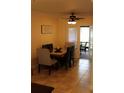 Dining area with modern chandelier, tile floors and view to back porch at 2463 Brookshire Ave, Winter Park, FL 32792