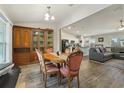 Open-concept dining area with hardwood floors, leading to a living room and kitchen at 3176 Sw 127Th St, Ocala, FL 34473