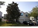 Charming two-story home featuring a two-car garage, well-maintained lawn, and mature trees adding curb appeal at 3334 Fawnwood Dr, Ocoee, FL 34761