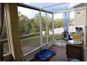 Screened patio with brick floor, white enclosure, view of the lawn, and outdoor furniture for relaxed entertaining at 3334 Fawnwood Dr, Ocoee, FL 34761