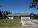 Charming single-story home with a well-manicured lawn and attached garage at 445 Live Oak Ave, Chuluota, FL 32766