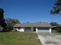 Charming single-story home with a well-manicured lawn and attached garage at 445 Live Oak Ave, Chuluota, FL 32766