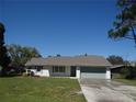 Charming single-story home with a well-manicured lawn and attached garage at 445 Live Oak Ave, Chuluota, FL 32766