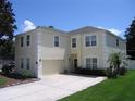 Delightful two-story home with an attached garage, a well-kept lawn, and an inviting facade at 506 Freeman St, Longwood, FL 32750