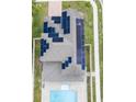 Aerial view of a home's roof featuring solar panels and a swimming pool at 5201 Villa Rosa Ave, St Cloud, FL 34771