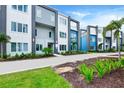 Stylish condo exterior showcasing modern architecture, colorful accents, and vibrant landscaping under a bright sky at 7740 Sandy Ridge Dr # 136, Reunion, FL 34747