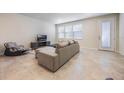 Spacious living room featuring neutral decor, large sectional sofa, and ample natural light at 9732 Brown Burrow St, Orlando, FL 32829