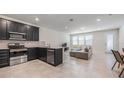 Open-concept living space connecting kitchen and living room, perfect for modern living and entertaining at 9732 Brown Burrow St, Orlando, FL 32829