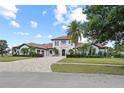An impressive Mediterranean-style home boasts lush landscaping and a grand entrance at 14645 Isleview Dr, Winter Garden, FL 34787