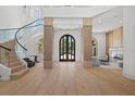 Bright foyer showcasing a winding staircase and custom millwork at 14645 Isleview Dr, Winter Garden, FL 34787