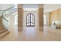 Bright foyer showcasing a spiral staircase, wood floors, and a view of the front entrance at 14645 Isleview Dr, Winter Garden, FL 34787