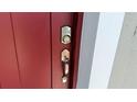 Inviting red front door with modern digital keypad and sleek handle at 15369 Sw 60Th Cir, Ocala, FL 34473