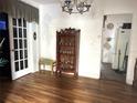 Dining room featuring a vintage display cabinet, wood floors, and an open doorway leading to another room at 1919 Waldo St, Orlando, FL 32806