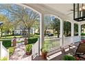 View from covered front porch showcasing brick walkway and meticulously maintained landscaping at 2090 Common Way Rd, Orlando, FL 32814