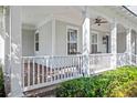 Spacious covered front porch featuring stylish white railings and ample outdoor seating at 2090 Common Way Rd, Orlando, FL 32814