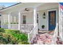 Inviting front porch features white pillars, a blue front door, and brick steps at 2090 Common Way Rd, Orlando, FL 32814