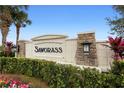 Elegant stone community sign with lush landscaping at the entrance of Sawgrass at 2145 Rush Bay Way, Orlando, FL 32824