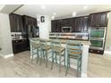 Gourmet kitchen featuring granite countertops, stainless steel appliances, and breakfast bar at 2351 Kelbrook Ct, Oviedo, FL 32765