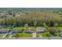 Aerial view of the home showcasing its location within a quiet residential neighborhood with mature trees at 260 La Paz Dr, Kissimmee, FL 34743