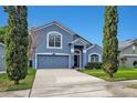 Two-story home with a two-car garage, appealing architectural details, and fresh landscaping at 275 Clydesdale Cir, Sanford, FL 32773