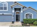 Close-up view of the home's front entrance with detailed architecture and manicured landscaping at 275 Clydesdale Cir, Sanford, FL 32773