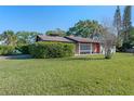 Expansive front yard of a brick single story home with mature landscaping and blue skies at 2805 Bongart Rd, Winter Park, FL 32792