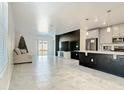 Open-concept living room features neutral tones, tile flooring, and sliding glass doors for seamless indoor-outdoor living at 2820 Black Birch Dr, Ocoee, FL 34761