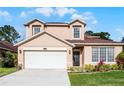 Charming two-story home with a well-manicured lawn and inviting curb appeal in a peaceful neighborhood at 3121 Bellingham Dr, Orlando, FL 32825