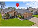 Charming single-story home with well-manicured lawn, inviting front door and a three car garage at 3710 Ahoya Ln, Orlando, FL 32837