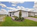 Inviting single-story home with a two-car garage and a freshly landscaped front yard at 4010 Copperleaf Ln, Poinciana, FL 34759