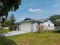 Single-story home with garage and driveway, showcasing its practical layout and curb appeal at 5622 Nokomis Cir, Orlando, FL 32839