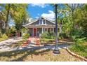 Classic home with a brick pathway, well-manicured lawn, and a quaint front porch at 647 E Livingston St, Orlando, FL 32803