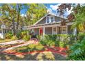 Inviting front porch and lush landscaping add to the curb appeal of this charming historic home at 647 E Livingston St, Orlando, FL 32803