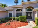 Inviting front entrance showcases manicured landscaping, decorative mulch, and a stylish front door at 712 Timberwilde Ave, Winter Springs, FL 32708