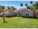 Beautifully landscaped front yard with lush lawn, mature trees, and a well-maintained single-story home at 712 Timberwilde Ave, Winter Springs, FL 32708