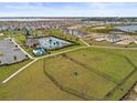 Aerial view of a community featuring a playground, pool, dog park, and waterfront access at 800 Griffon Ave, Lake Alfred, FL 33850