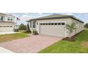 Charming one-story home features a two-car garage, brick driveway, and well-kept landscaping at 800 Griffon Ave, Lake Alfred, FL 33850