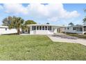 Inviting single-story home with a spacious lawn and covered parking at 1028 Capella Dr, Tavares, FL 32778