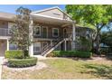 Charming two-story building with lush landscaping and exterior staircase at 109 Reserve Cir # 201, Oviedo, FL 32765