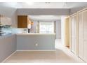 Open kitchen with breakfast bar, white appliances, and tile floors at 109 Reserve Cir # 201, Oviedo, FL 32765