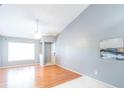 Bright living room with wood floors, vaulted ceiling, and ceiling fan at 109 Reserve Cir # 201, Oviedo, FL 32765