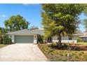 Well-maintained home with a spacious driveway and a lush, green lawn at 111 Woodstream Ct, Maitland, FL 32751