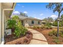 Inviting home exterior with a paved walkway and manicured landscaping at 111 Woodstream Ct, Maitland, FL 32751