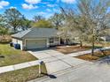 This aerial view shows the home, driveway, and surrounding neighborhood at 1137 Stratton Ave, Groveland, FL 34736