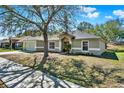 Lovely single-story house with an attached garage and well-kept landscaping at 1137 Stratton Ave, Groveland, FL 34736