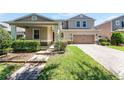 Charming home featuring a brick pathway, well-manicured lawn, and freshly trimmed hedges at 11926 Verrazano Dr, Orlando, FL 32836